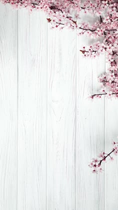 a white wooden wall with pink flowers on it