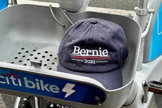 a baseball cap sitting on the back of a scooter