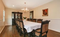 a dining room table with chairs and a chandelier