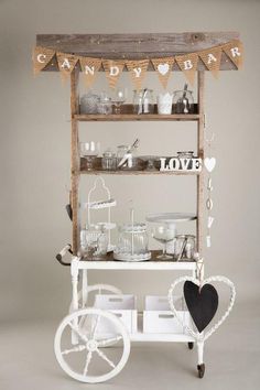 an old cart is decorated with hearts and bunting on the top for candy bar