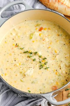 a pot filled with soup next to bread