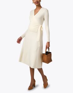 Add a chic layer to your transitional dressing this season with Allude's cardigan. Knit to a fine rib texture from 100% wool, the wrap silhouette lends a ladylike fit to this wardrobe staple. Dress it up with the coordinating skirt or keep it casual with jeans for a versatile look you'll love all season. White Knit Wrap Dress, Dress Layers, Skirt And Top Dress, Transitional Dressing, Staple Dress, Cashmere Outfits, Knit Wrap Dress, Textured Cardigan, Cardigan Knit