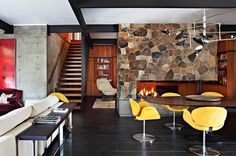 a living room filled with furniture and a fire place next to a wall mounted fireplace