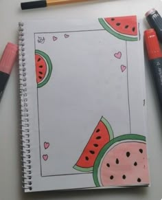 a notebook with watermelon and hearts on it next to markers, pencils and marker pens