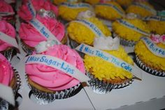 cupcakes decorated with pink and yellow frosting are on display for people to eat