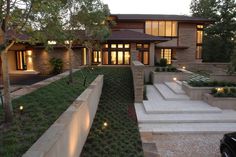 a house with steps leading up to the front door and landscaping on either side of it