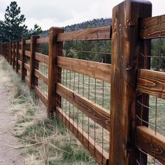 a wooden fence in the middle of a field