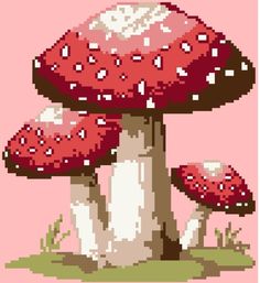 three red mushrooms sitting on top of a green field in front of a pink background