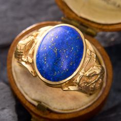 This mens statement ring showcases an oval lapis cabochon with plenty of pyrite flecks. The lapis is bezel-set into a ring with hissing cobra details on each shoulder. The ring is crafted in 14k yellow gold and is currently a size 8.75. Luxury Lapis Lazuli Oval Rings, Luxury Oval Lapis Lazuli Rings, Luxury Oval Lapis Lazuli Jewelry, Golden Rings For Men, Kubler Ross, Serpent Ring, Golden Ring, Human Form, The Ring