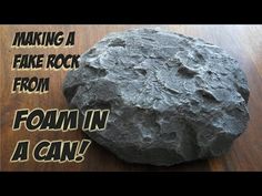 a rock sitting on top of a wooden table next to a sign that says making a fake rock from foam in a can