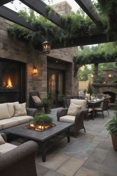 an outdoor living area with couches, tables and fire pit in the middle of it