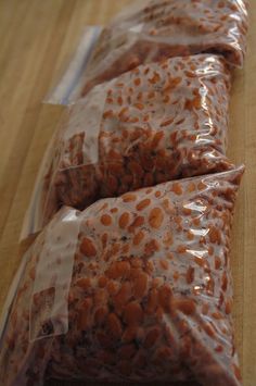 three bags of food sitting on top of a wooden table