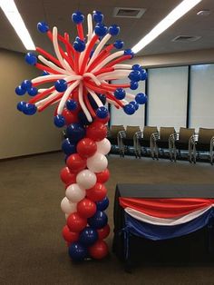 an american flag balloon column with red, white and blue balloons in the shape of fireworks