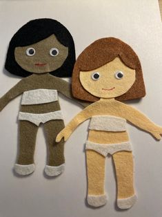 two felt dolls sitting next to each other