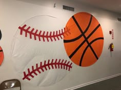 sports themed wall hangings in an office space with basketball and baseball balls on the wall