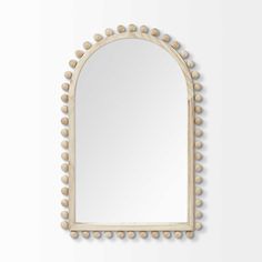 a mirror with some balls on it and a white wall in front of the mirror