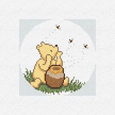 winnie the pooh cross stitch pattern with honey pot and bees in it, sitting on grass