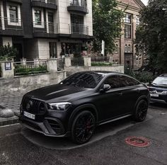 a black mercedes suv parked on the street