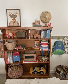 a bookshelf with toys and other items on it in a child's room