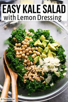 Kale salad with toppings in glass bowl with salad tongs. Title: Easy Kale Salad with Lemon Dressing. Chik Fil A Lemon Kale Salad Recipe, Lemon Garlic Kale Salad, Parmesan Kale Salad, Happy Hormone Vegan Lemon Kale Caesar Salad, Kale Chickpea Salad, Kale Lemon Parmesan Salad