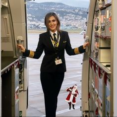 a woman in an airplane doorway with her arms out