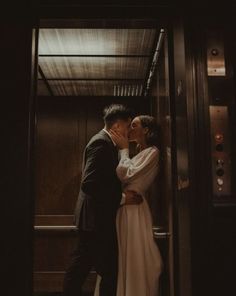 a bride and groom kissing in the elevator at their wedding reception, photographed by nyc elopement photographer