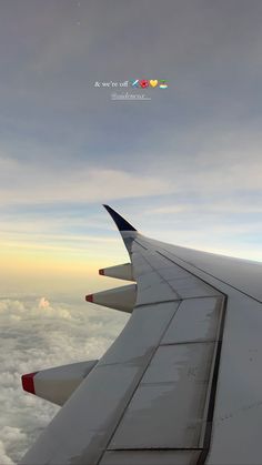 the wing of an airplane flying high above the clouds