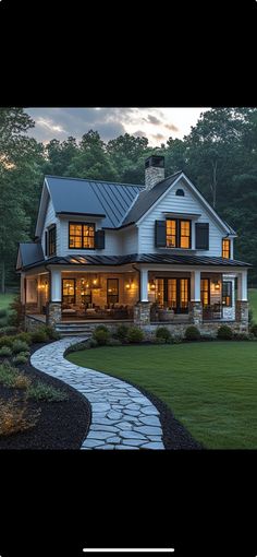 a large white house sitting on top of a lush green field