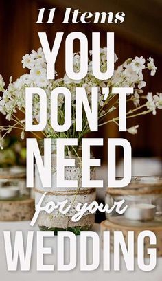 a vase filled with white flowers sitting on top of a table next to mason jars