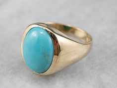 This vintage yellow gold ring dates to the Mid Century period, with sleek lines and a lack of adornment. The very simple design means that the beauty of the ring is dependent on the balance and polish of its golden frame. A simple bezel surrounds the stone, and really helps to set off the gorgeous teal coloring of the turquoise! Metal: 10K Yellow Gold Gem: Turquoise Gem Measurements: 15.4 x 11.4 mm, Oval Ring Size: 10.75 Marks: "10K" Stamped on the inside band Ring Blue Stone, Turquoise Gem, Turquoise Belt, Turquoise Gold Ring, Right Hand Ring, Nugget Necklace, Golden Frame, Turquoise Accents, Ring Turquoise