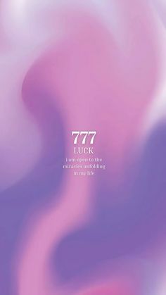 an abstract blurry background with the words 777 luck in white and light pink