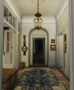 the hallway is decorated with antique rugs and ornate lighting fixture hanging from the ceiling