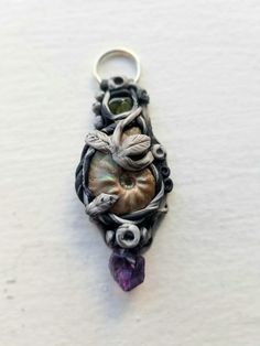 Handmade Polymer Clay Crystal Pendant with Amethyst, Ammonite and Peridot Necklace Nature-inspired Pendant Jewelry For Crafting, Handmade Green Amethyst Gemstones, Nickel-free Amethyst Jewelry, Unique Amethyst Nickel-free Jewelry, Purple Nature-inspired Jewelry With Natural Stones, Nature-inspired Purple Jewelry With Natural Stones, Purple Natural Stones Jewelry, Nature-inspired, Collectible Amethyst Pendant Jewelry, Purple Soldered Pendant Jewelry