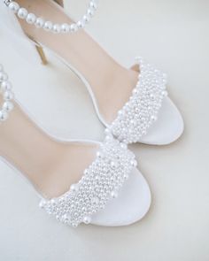 the bride's shoes are adorned with pearls