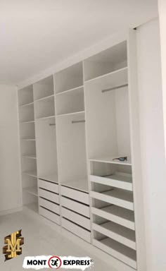 an empty walk in closet with white shelves