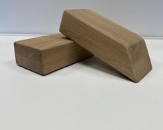 two pieces of wood sitting next to each other on top of a white countertop