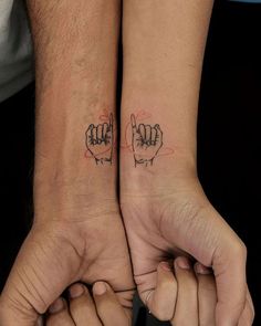 two people with matching tattoos on their arms