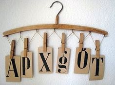 wooden letters hang from clothes pins on a coat rack that says apxo to go