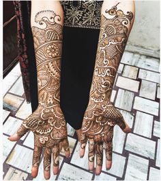 two hands with henna designs on them