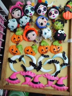 a table topped with lots of different halloween themed items on top of a wooden tray