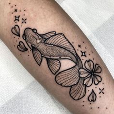 a black and white image of a fish with flowers on it's leg,