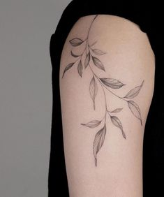 a woman's arm with leaves on it