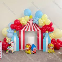 a circus themed birthday party with balloons and clowns in front of the entrance to the tent