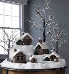 a christmas scene with snow covered houses and trees