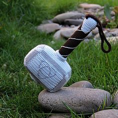 a knitted object sitting on top of a rock