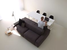 a man sitting at a table on top of a couch