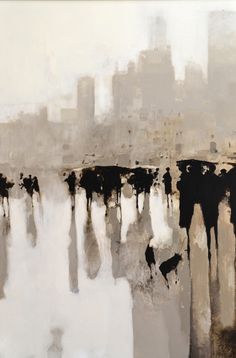 an abstract painting with black and white paint on the bottom half of it, in front of a cityscape