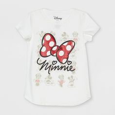 Give your girl something bow-tiful to wear like the Minnie Mouse Bow Short-Sleeve T-Shirt from Disney. Made from a breathable cotton blend with a curved hemline, the below-waist pullover tee will feel nice and comfy no matter what she?s doing, while the versatile ivory hue makes it easy to pair with any color of bottoms. It showcases an illustration of a red polka-dot bow with "Minnie" text, set against a backdrop of blurred images of Mickey and Minnie striking different poses. Size: XL. Gender: Minnie Mouse Shirt, Disney Gift Card, Minnie Mouse Dress, Minnie Mouse Bow, One Piece Clothing, Minnie Mouse Girl, Disney Gift, Bow Shorts, White Graphic Tee