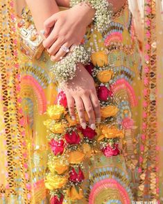 a close up of a person wearing a dress with flowers on it's belt