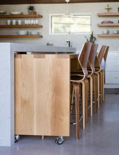 a kitchen with several chairs and a counter